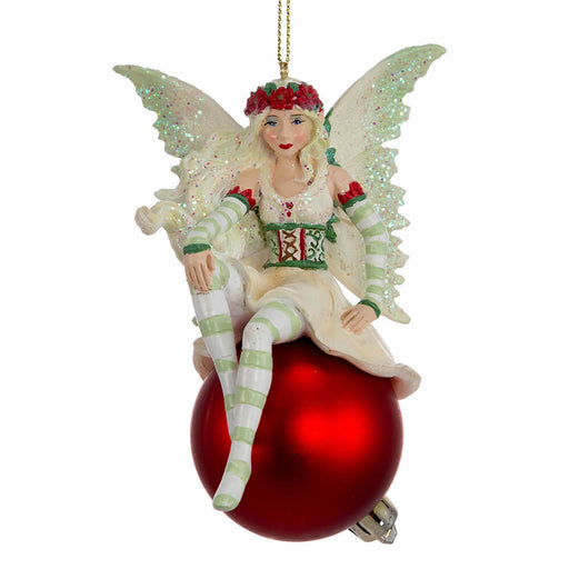 Amy Brown fairy ornament in shades of green and white, with pixie sitting on a red ornament ball.