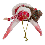 Top down view of Amy Brown fairy ornament of pixie dressed in red Santa Claus outfit.