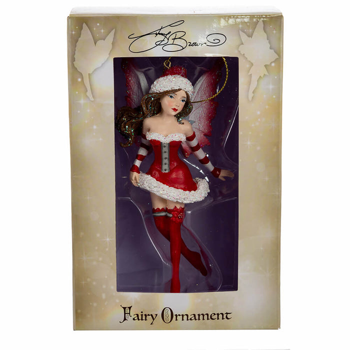 Amy Brown fairy ornament of pixie dressed in red Santa Claus outfit. Shown in window box