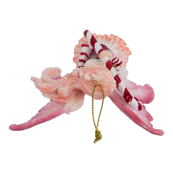 Top down view of Amy Brown Fairy ornament in red, pink, and white, holding a candy cane.