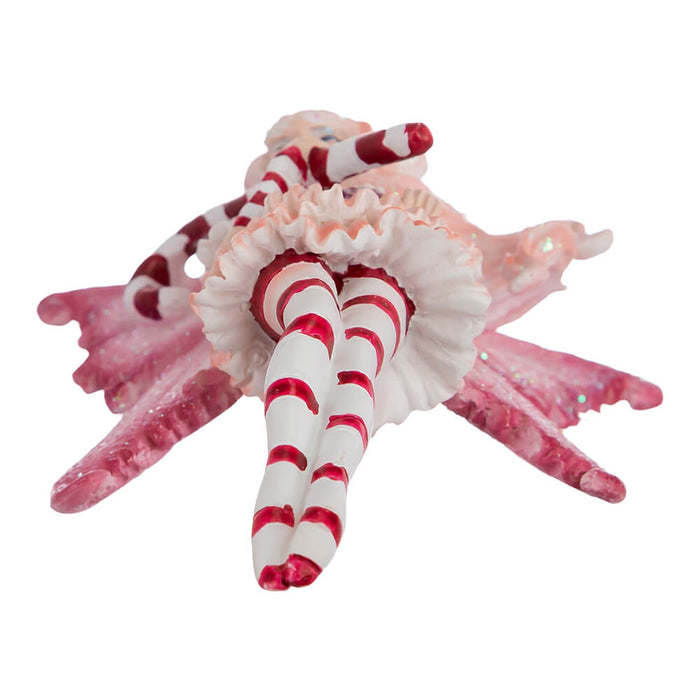 Bottom view of Amy Brown Fairy ornament in red, pink, and white, holding a candy cane.