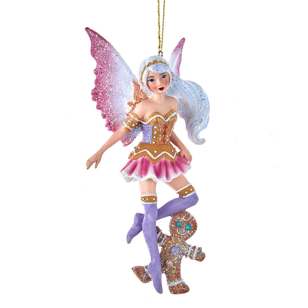 Fairy ornament by Amy Brown with pink wings and shirt, brown and purple accents, and a gingerbread man