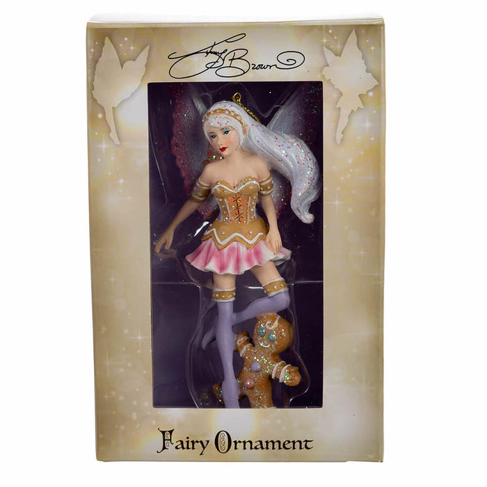 Fairy ornament by Amy Brown with pink wings and shirt, brown and purple accents, and a gingerbread man. Shown boxed with window