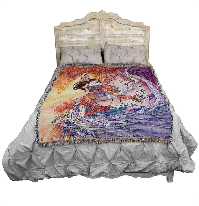 Butterfly fairy tapestry blanket displayed on a bed