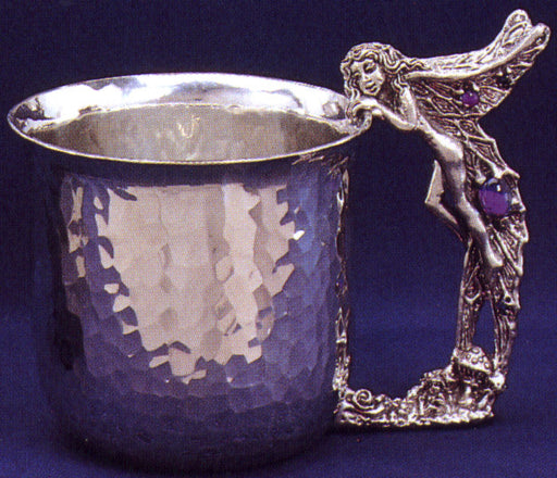 hammered pewter cup with fairy looking in and same fairy as the handle inlayed with gems.