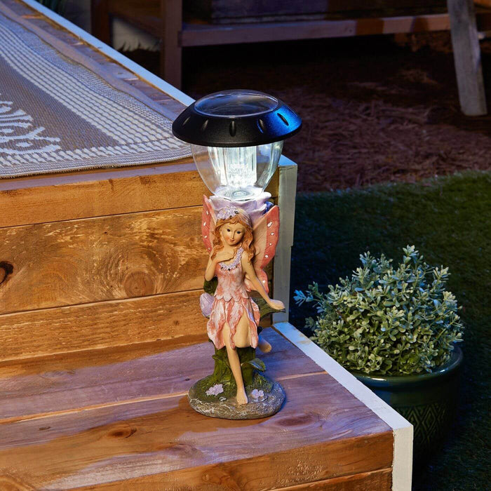 Fairy solar light at night, lit up and accenting the step of a deck