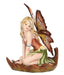 A blond fairy with a brown and green flower dress and tan wings sits in a leaf boat
