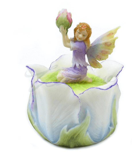 Trinket box featuring a fairy in purple holding up a pink flower bud. She has yellow tipped wings and sits on a white tulip blossom that forms the box.