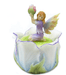 Trinket box featuring a fairy in purple holding up a pink flower bud. She has yellow tipped wings and sits on a white tulip blossom that forms the box.