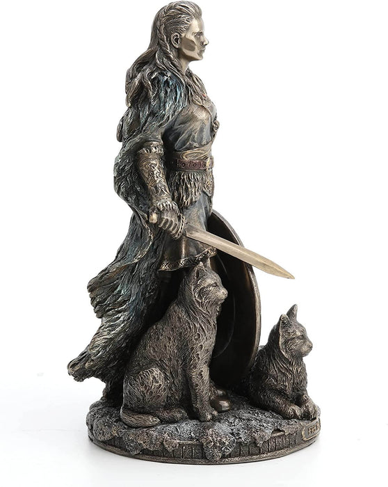 Shieldmaiden Freya the Norse goddess standing with sword, shield, and two cats, shown from the side