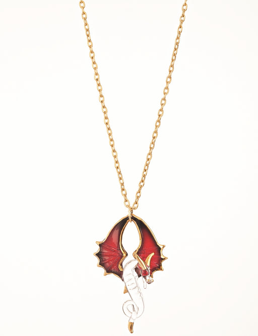 Glass necklace charm features a clear dragon with red wings curving upwards, and gold accents. Red crystal eyes sparkle, and the pendant hangs from a gold chain