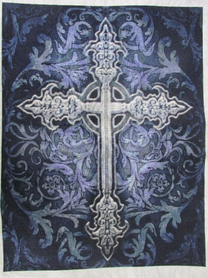 Finished cross stitch of a silver Gothic cross against a purple brocade background