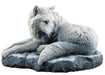 Guardian of the North wolf figurine by Lisa Parker. A white wolf lays on a snowy rock, looking back.