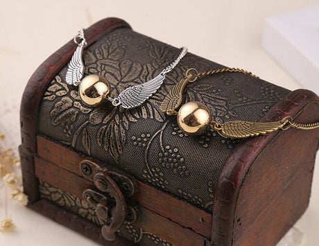 Harry Potter Golden Snitch bracelets shown in both finishes, silver and antique gold