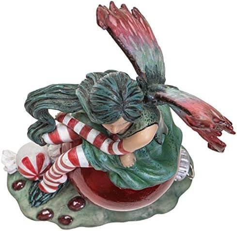 Fairy Figurine in red and green with holly leaves and berries, by artist Amy Brown. Top view