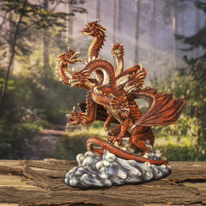 Red Hydra Dragon figurine shown in a forest setting on tree bark