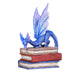 A blue dragon perches on a stack of three books