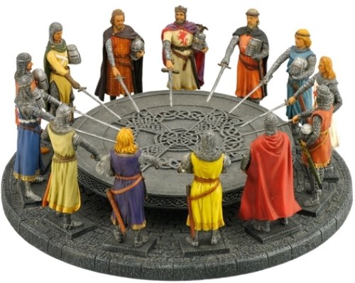 King Arthur and the Knights of the Round Table all pose around the circular table, with their swords drawn and pointing at the center. The table has Celtic knot designs upon it.