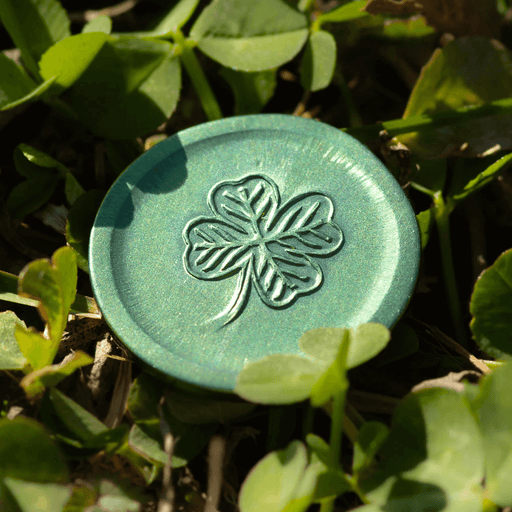 Green Lucky coin sitting in clover showing its clover side
