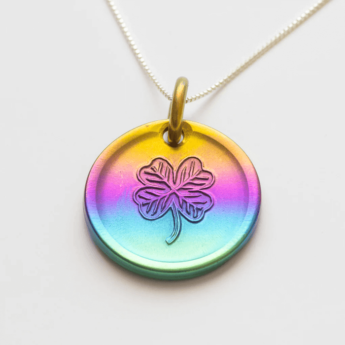 Rainbow lucky coin charm showing clover, on silver chain