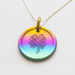 Rainbow lucky coin charm showing clover, on silver chain