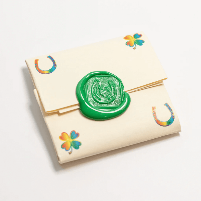 Packaging for Rainbow lucky coin charm showing wax seal and rainbow decorations