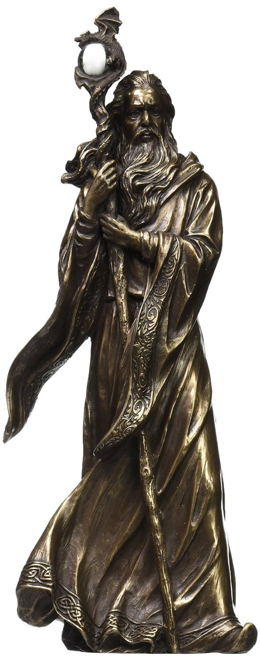 Bronze colored statue of Merlin the wizard holding a staff