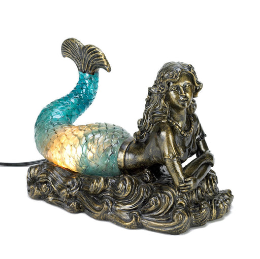 Lamp featuring a bronze colored mermaid with a glowing blue tail