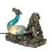 Lamp featuring a bronze colored mermaid with a glowing blue tail