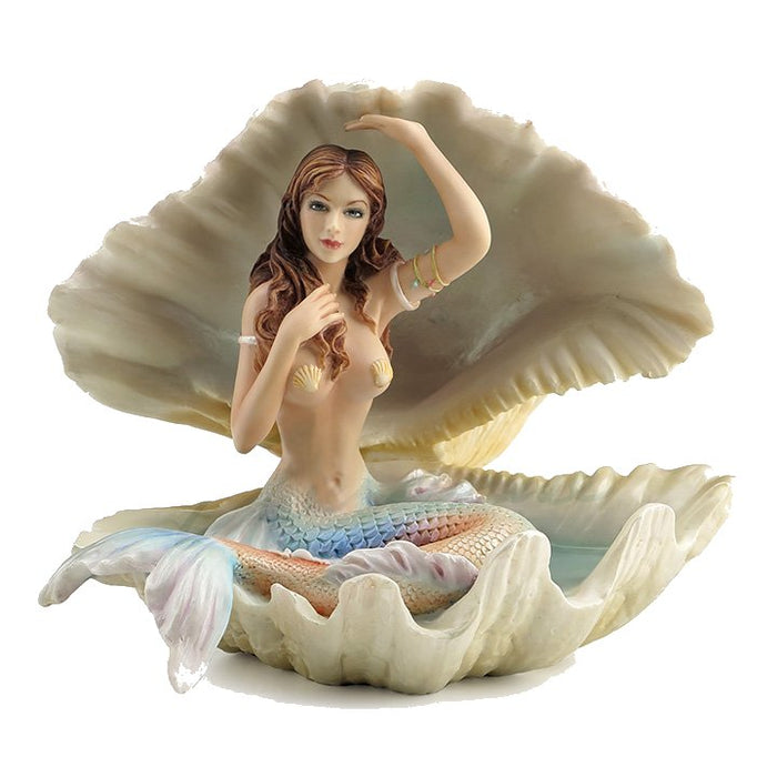 Mermaid with pastel rainbow tail and brunette hair sitting in a seashell