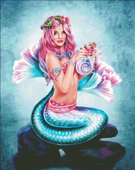 Cross stitch finished pattern showing a blue mermaid with pink and purple hair, holding a shell full of flowers