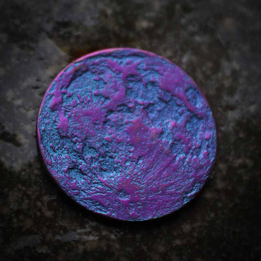 Blue-purple full moon coin, one side shown