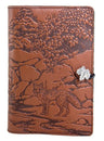 Brown leather journal with engraved fox and nature scene, featuring a silver leaf closure.