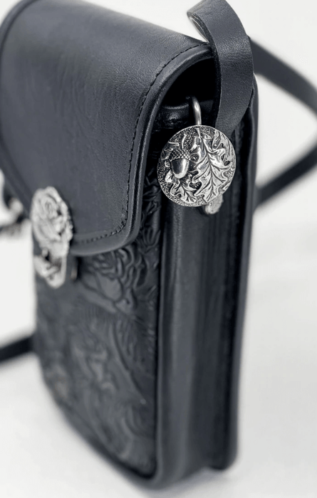 Oak leaf and acorn purse hook medallion used in a black leather bag