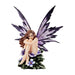 A nude fairy tucks her knees up to her chin while sitting amidst periwinkle flowers. Her wings are purple and black and she has brown hair!