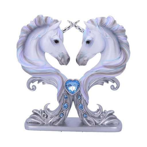 Figurine with two unicorn busts facing one another, silver horns crossed. Unicorns are done in shades of white and pale silver, blue and purple. A light cyan heart gem and three oval blue gems adorn the front of the base.