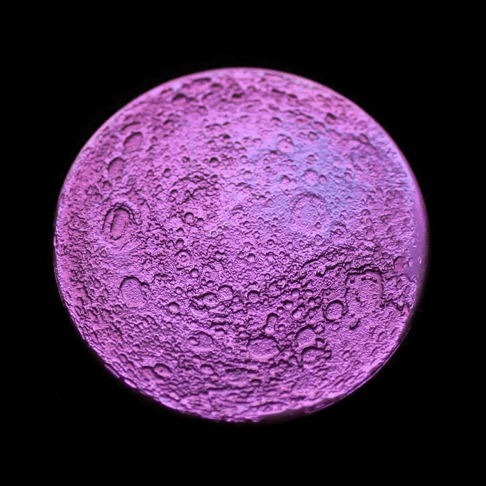 Other side of the anodized niobium full moon coin in purple