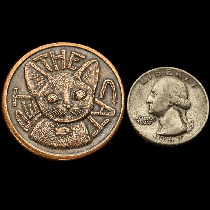 Size comparison of decision maker coin next to quarter