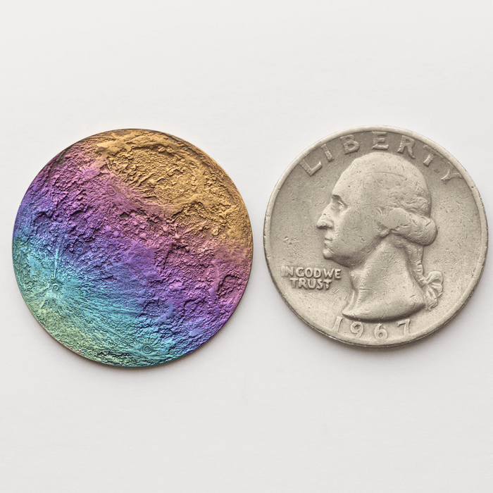 Size comparison of 1" rainbow full moon coin, and a US quarter