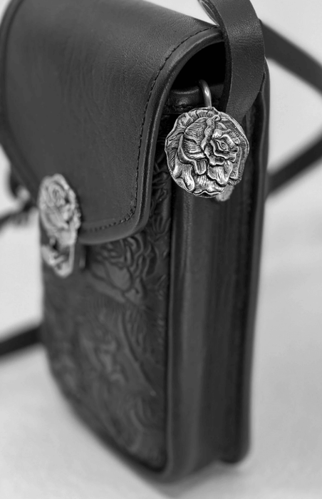 Pewter rose key hook shown in use in a black purse