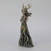 A tree spirit stands holding a rabbit, hair blowing in a breeze and antlers on her head.