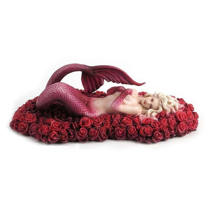 Mermaid with pink scales and white-blond hair laying on a bed of red roses