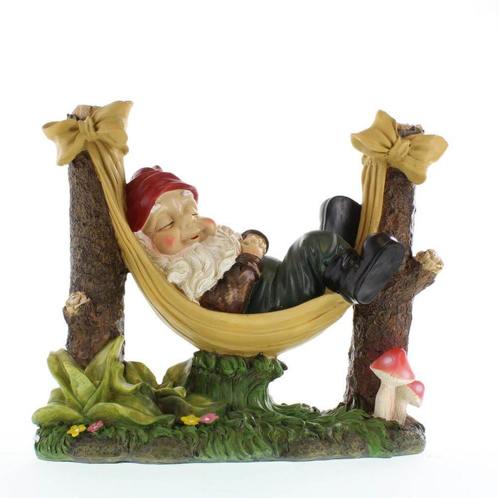 Garden gnome in a hammock sleeping