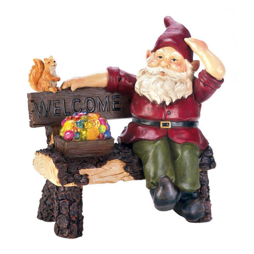 Solar garden gnome sitting on bench with light-up box of treasure and jewels. Squirrel perches nearby