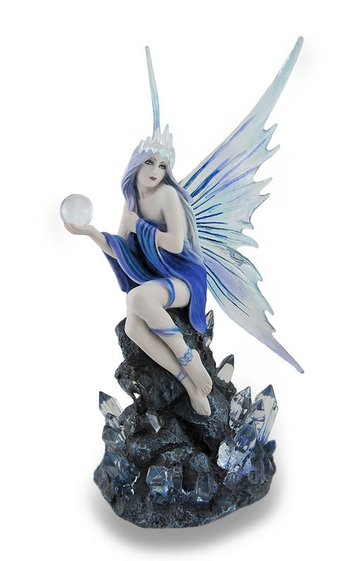 Fairy in blue with transparent wings and an ice crown, holding a crystal ball. She sits on a rock adorned with crystals