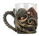 Shot glass with handle. The glass is encased in a Steampunk octopus design, where a tentacle forms the handle