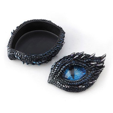 Trinket box shaped like the eye of a dragon. Thorny scales surround the blue eye. Shown with the lid removed.