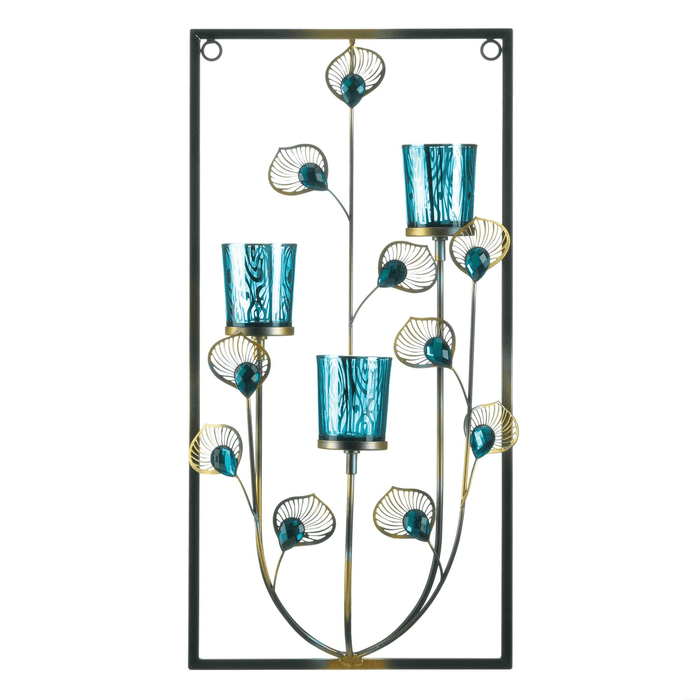 Peacock themed wall sconce candle holder. Votive holders in shades of blue are held amidst jeweled feather-like stems in a rectangular frame. Has three candle holders.