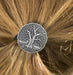 Tree of Life ponytail holder shown worn in blond hair