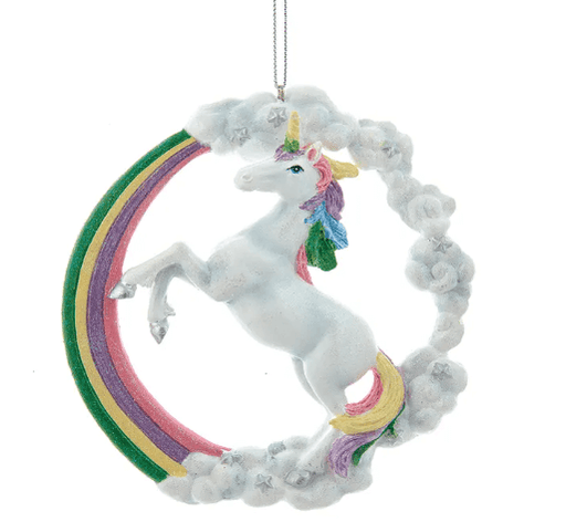White unicorn with colorful mane and tale rearing up in front of a rainbow with clouds accented in stars